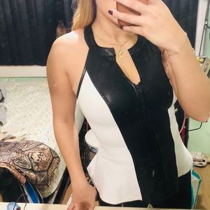 Sleeveless white top with black leather details